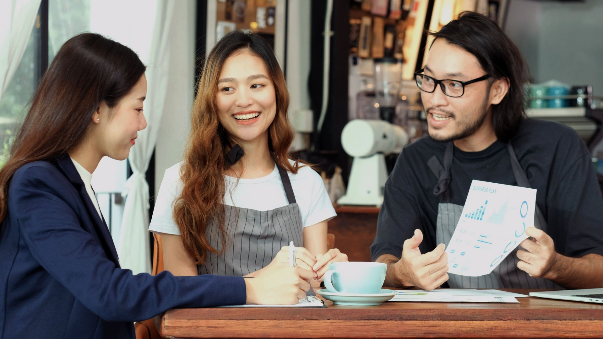 Young asian business woman discussing about financial planning with small business owner at cafe coffee shop, Business meeting corporate partnership, Asia financal loan for start up new business